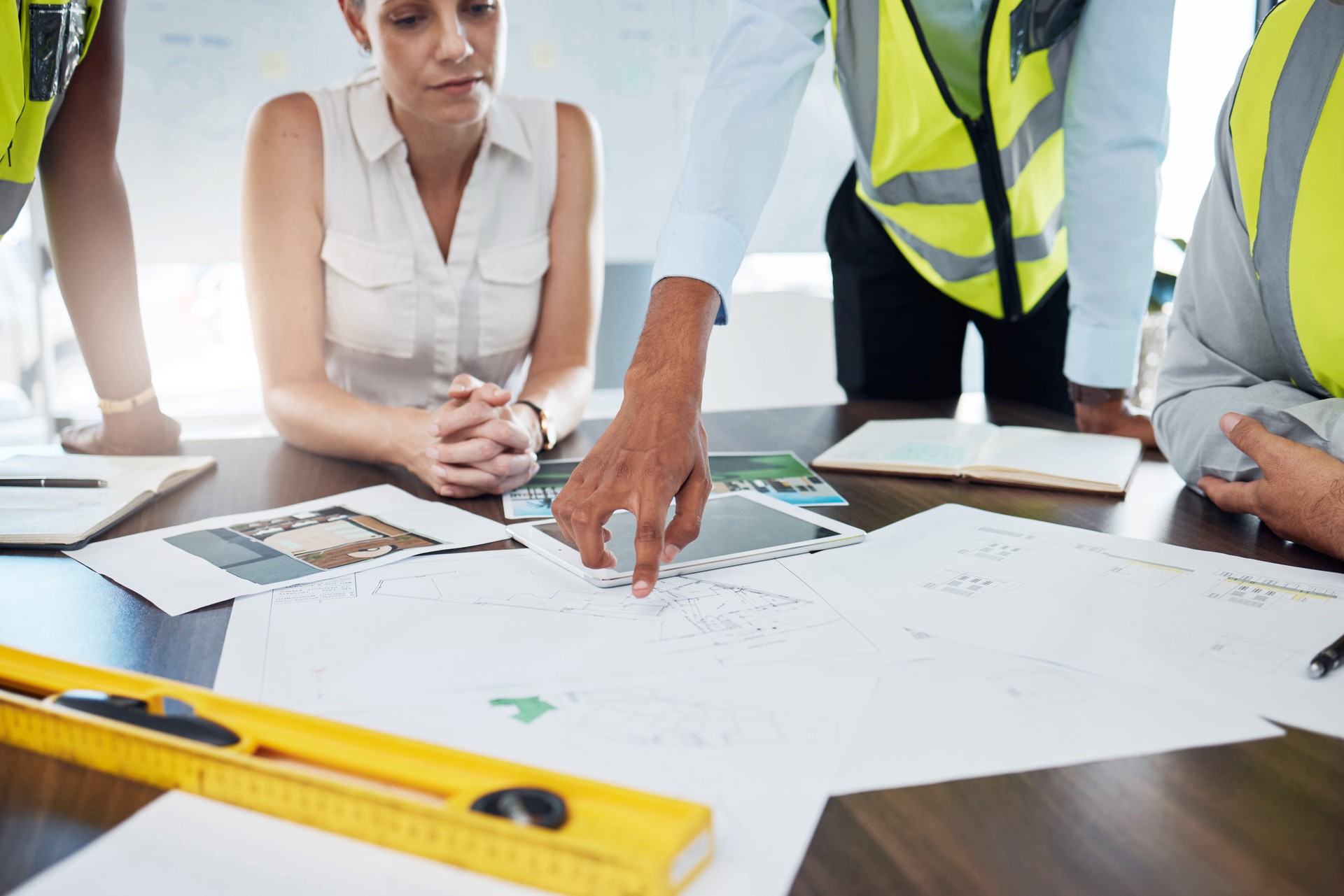 Construction, blueprint and planning with architect in meeting for consulting, project management and vision. Design, engineering and construction site plans with team of designers or contractors